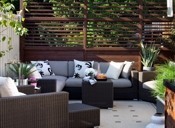 Comfortable terrace with decorative wooden privacy screens