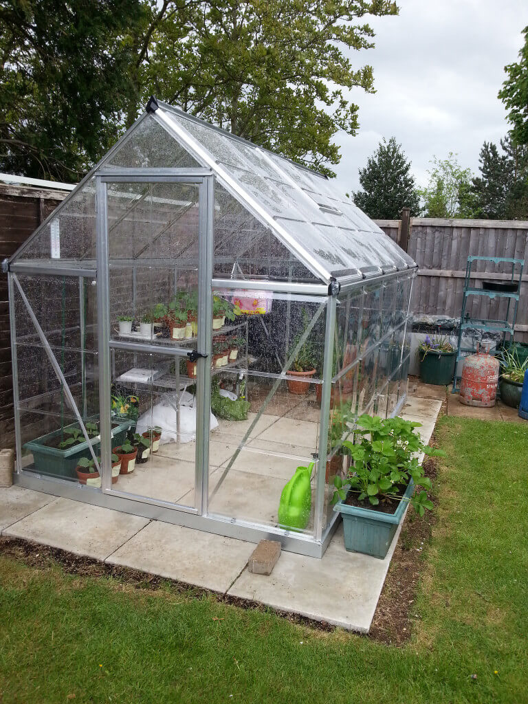 backyard greenhouse this is a small freestanding greenhouse on a stone stab out in VFTYAYT