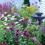 cottage garden bright and airy flower garden with white fence WVOMNCU