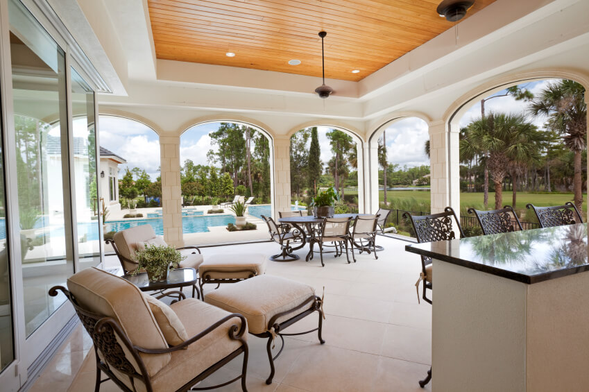 covered patio ideas this massive covered stone tile patio features a small bar in addition NOJMYVI