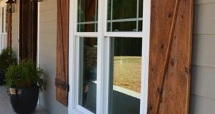 grey exterior with wooden shutters and brick bottom BGSGMRI