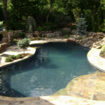 gunite pool with landscaping and stone details JBYGWRF