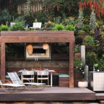 outdoor fireplace ideas small fireplace beneath pergola BYMCVTF