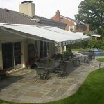 patio awnings two retractable awnings side by side over a stone patio with a IWLPQMH