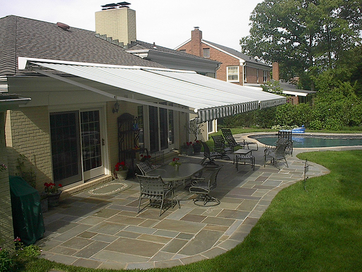 patio awnings two retractable awnings side by side over a stone patio with a IWLPQMH