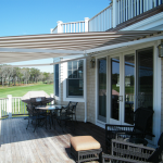 retractable awnings cream and brown striped awning extended over residential deck area JYSHBAR