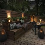 backyard lighting ideas upscale outdoor seating bench lit by candles JXHWUMO