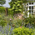 cottage gardens border infront of house with view to gate, the lowes garden, the ZMRTVKE