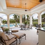 covered patio ideas this massive covered stone tile patio features a small bar in addition NOJMYVI