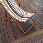 dark stained bamboo decking whith a deckchair YOKVZQP
