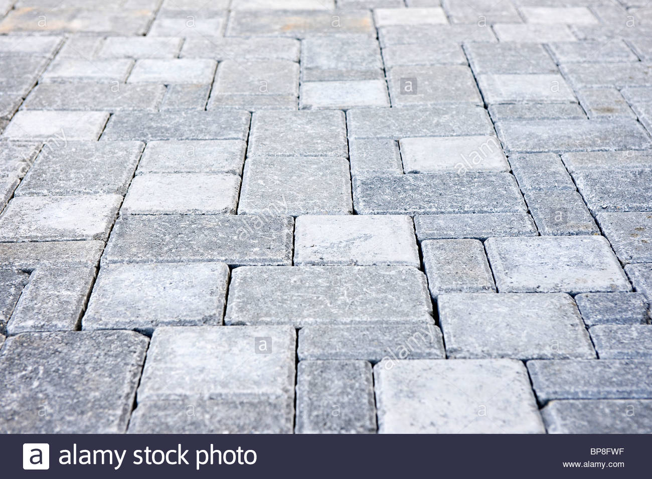 gray interlocking paving stone driveway from above - stock image ODUZJGM
