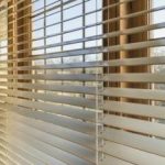 horizontal blinds gleaming horizontal wood blinds run across a bank of windows. WRFBRKE