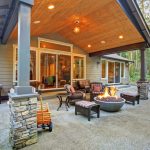 large back yard with grass and covered patio with fire pit XLRHZPZ
