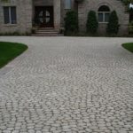 large brick driveway in front of luxury home FYNFVEH