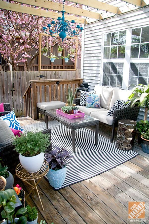 outdoor decorating ideas adding a lighting fixture and pattern pillows brings personality to this YAJBNEL