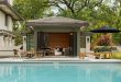 pool house ideas bifold glass doors allow for an extended entertaining area in this chic XZRLXTK