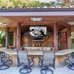 the outdoor kitchen has a hanging tv perfect for a weekend barbecue WAOYQZK