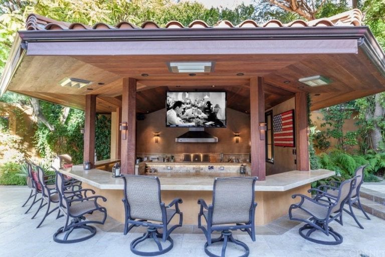 the outdoor kitchen has a hanging tv perfect for a weekend barbecue WAOYQZK
