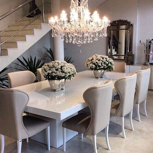 Sleek white table with ivory/beige dining chairs, top off the
