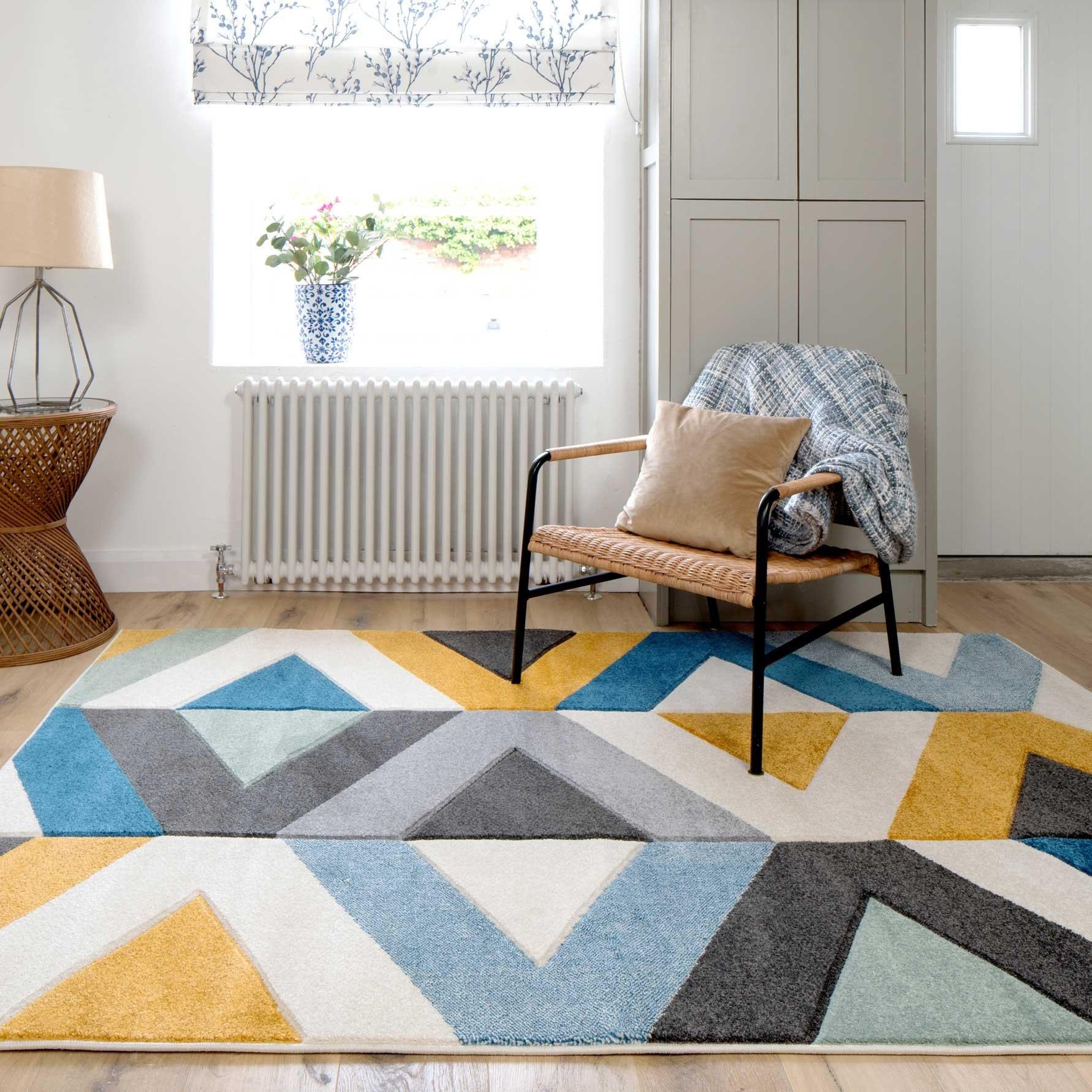 Try out‌ fun, geometric patterns with a rug in your blue living room