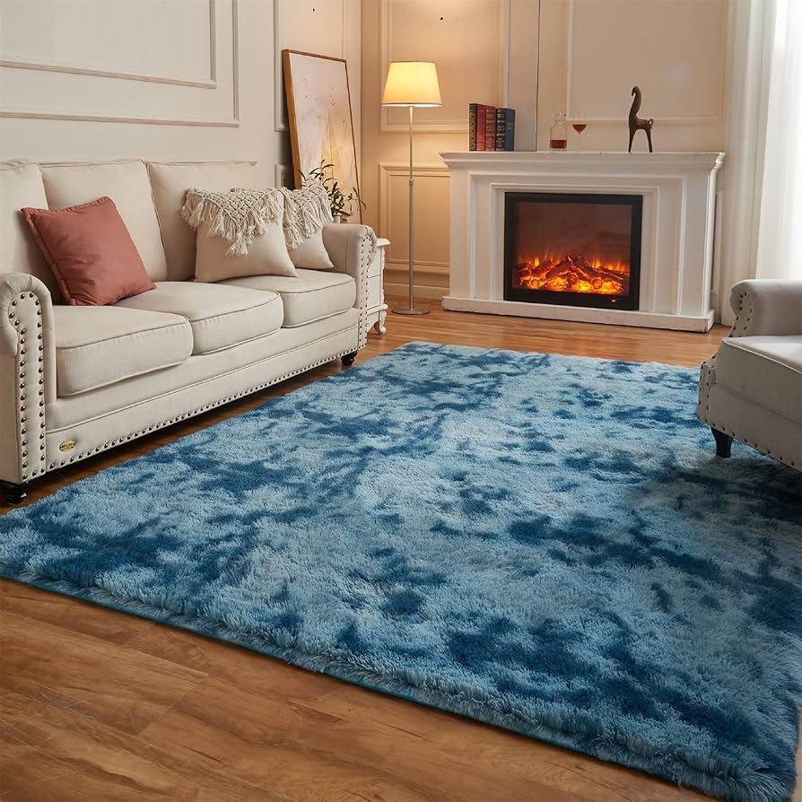 Layered rugs bring depth to a blue ‍living room design