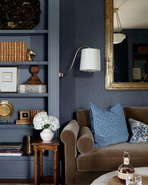 Textured fabrics enhance ⁤comfort in‍ a cozy ⁣blue ⁢living room