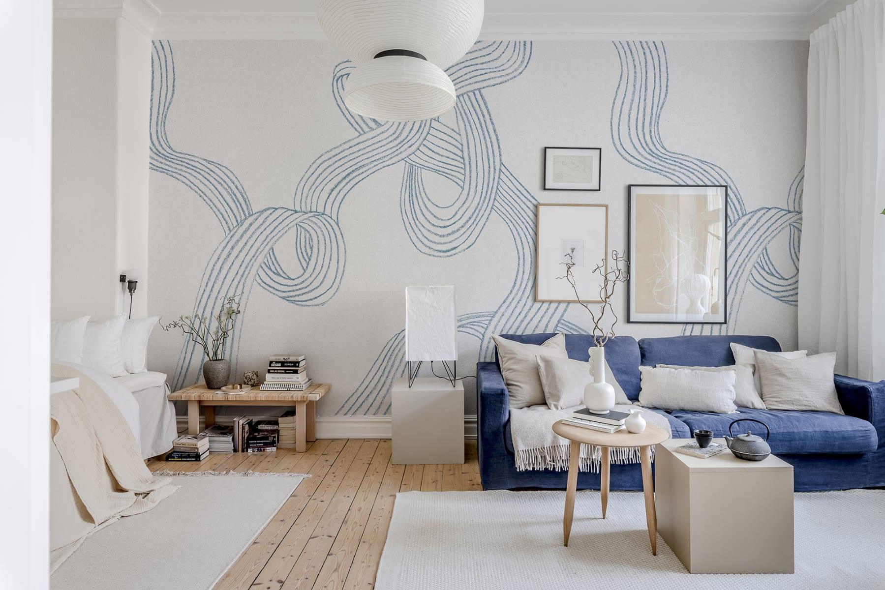 Soft blue wallpaper creates an inviting ​backdrop in your‌ living room