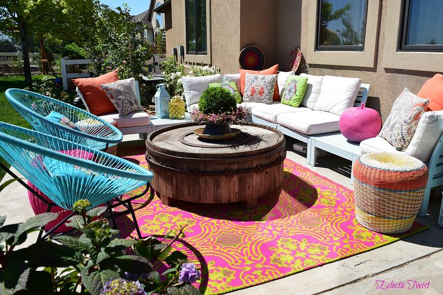 Use colorful rugs and pillows for comfort in your backyard oasis