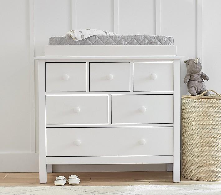 Install a changing pad on top of dresser in small nursery