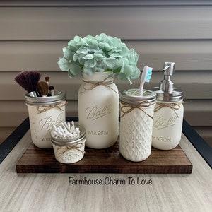 Decorate with mason⁢ jars⁢ for a charming touch in your farmhouse bathroom