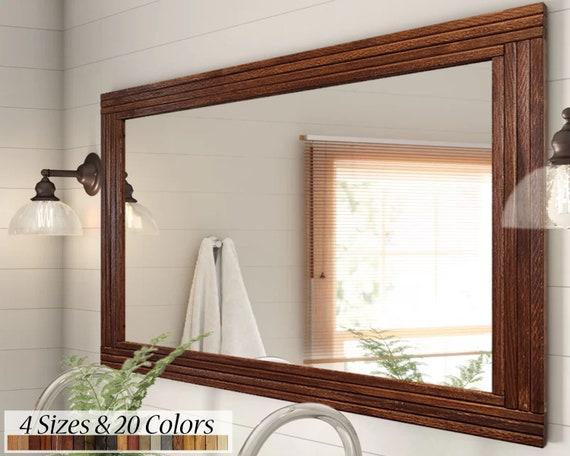 Hang‌ a large⁣ mirror with a wooden ⁣frame‍ to contrast against your wooden bathroom