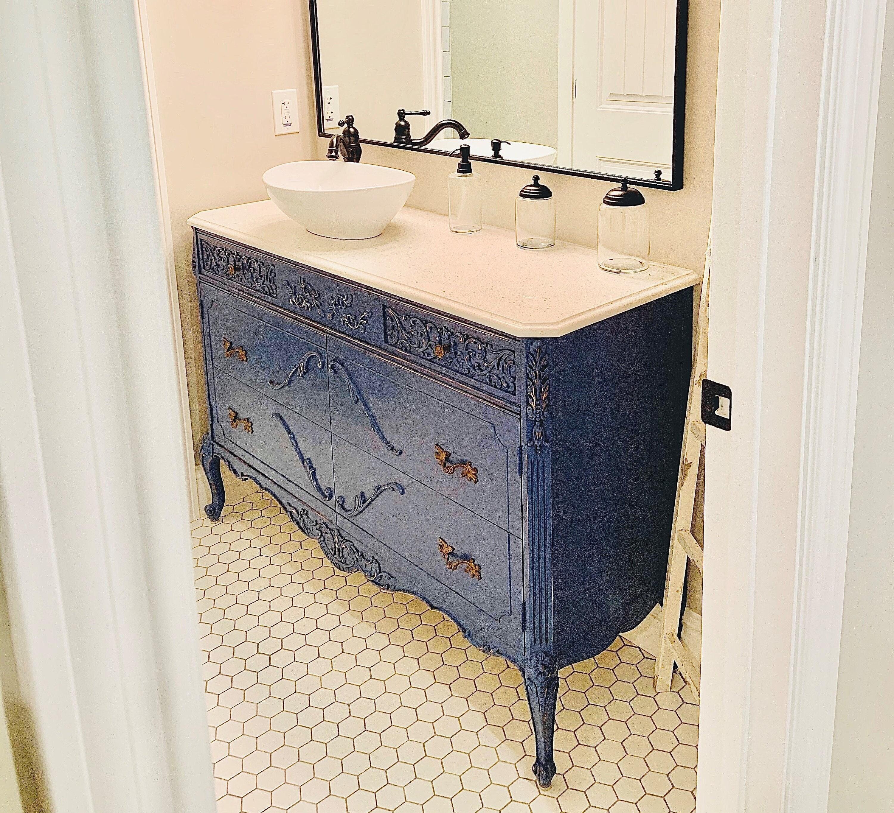 Reimagine a vintage dresser as a sink vanity in your eclectic bathroom