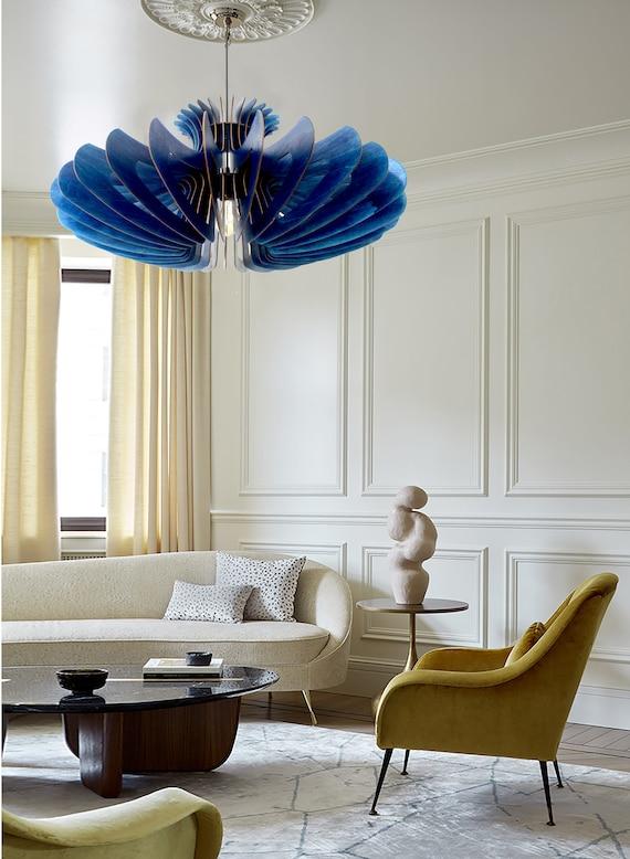 Experiment ‌with eclectic lighting fixtures in the blue living room