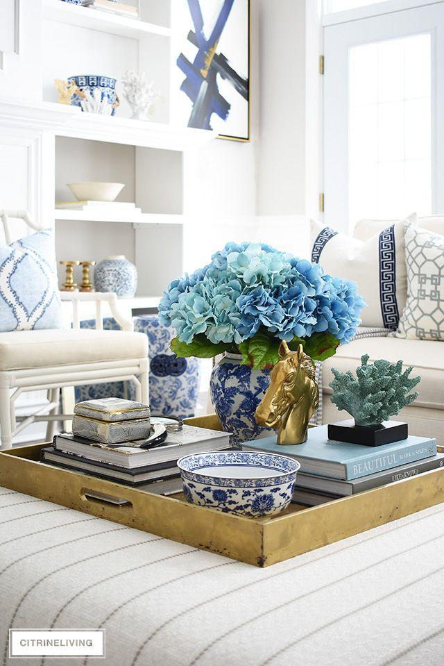 Use decorative​ trays to organize items in your blue living room