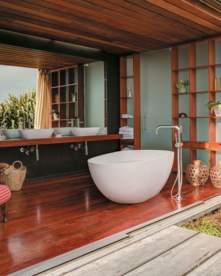 Frame your tub with wooden bathroom decking for an outdoor-inspired oasis