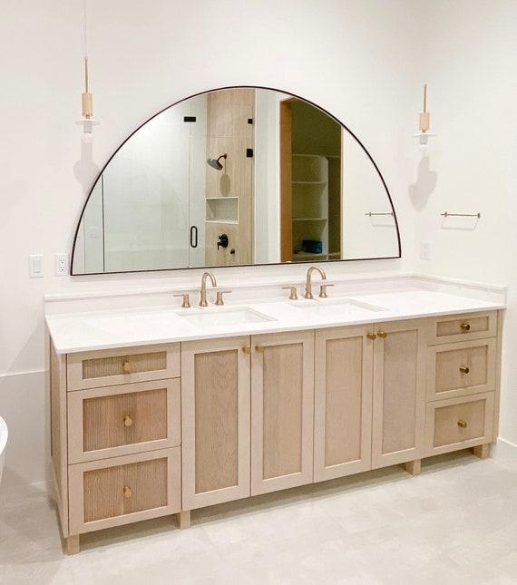 An oversized mirror to create an inviting boho bathroom atmosphere