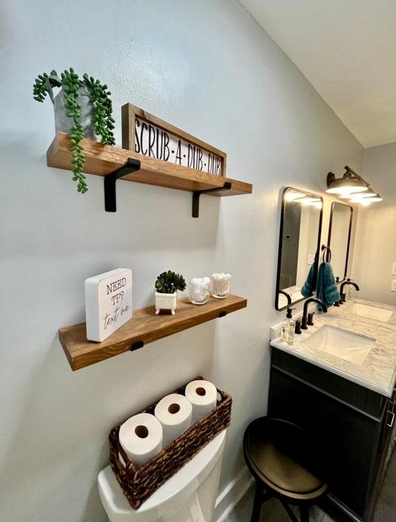 Opt for wooden shelving to showcase decor in your cozy wooden bathroom