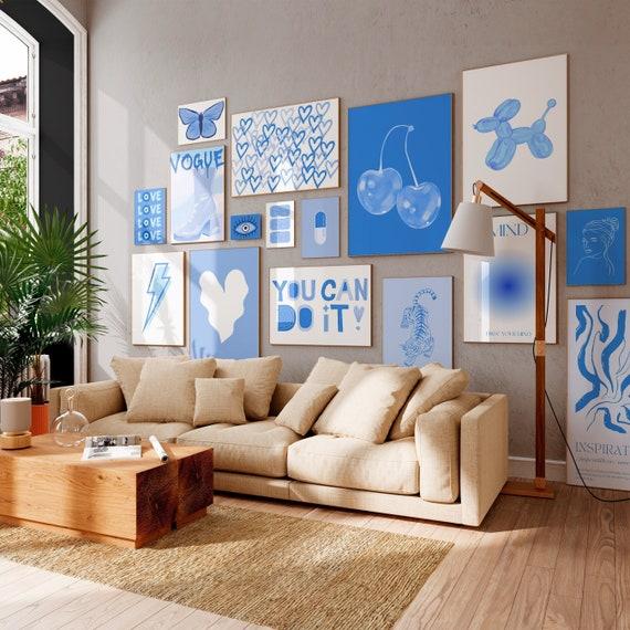 Design a gallery ⁤wall featuring ​photos ⁤in‍ your blue living room