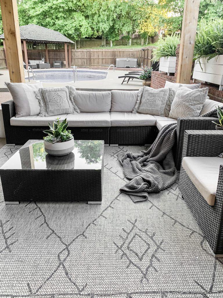 Use​ outdoor rugs to define spaces on your screened porch