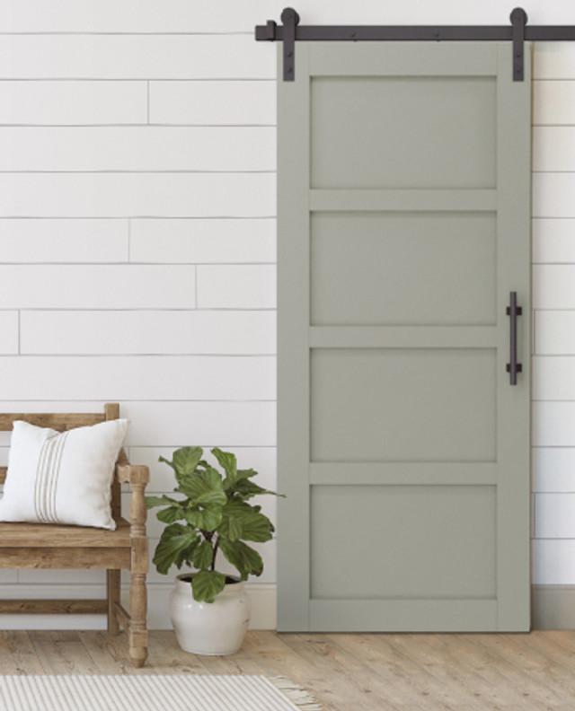 A chic barn door offers both style and functionality in your farmhouse bathroom