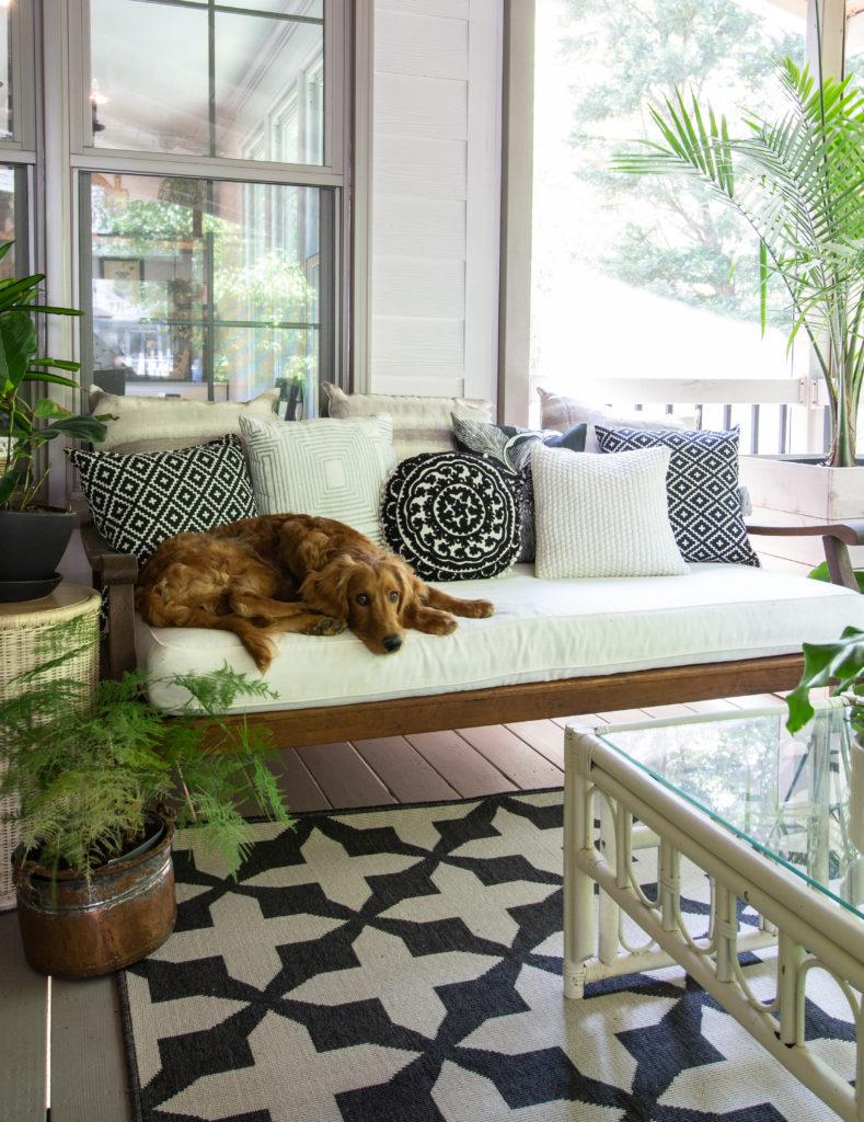 Add comfortable seating for relaxation on your screened porch