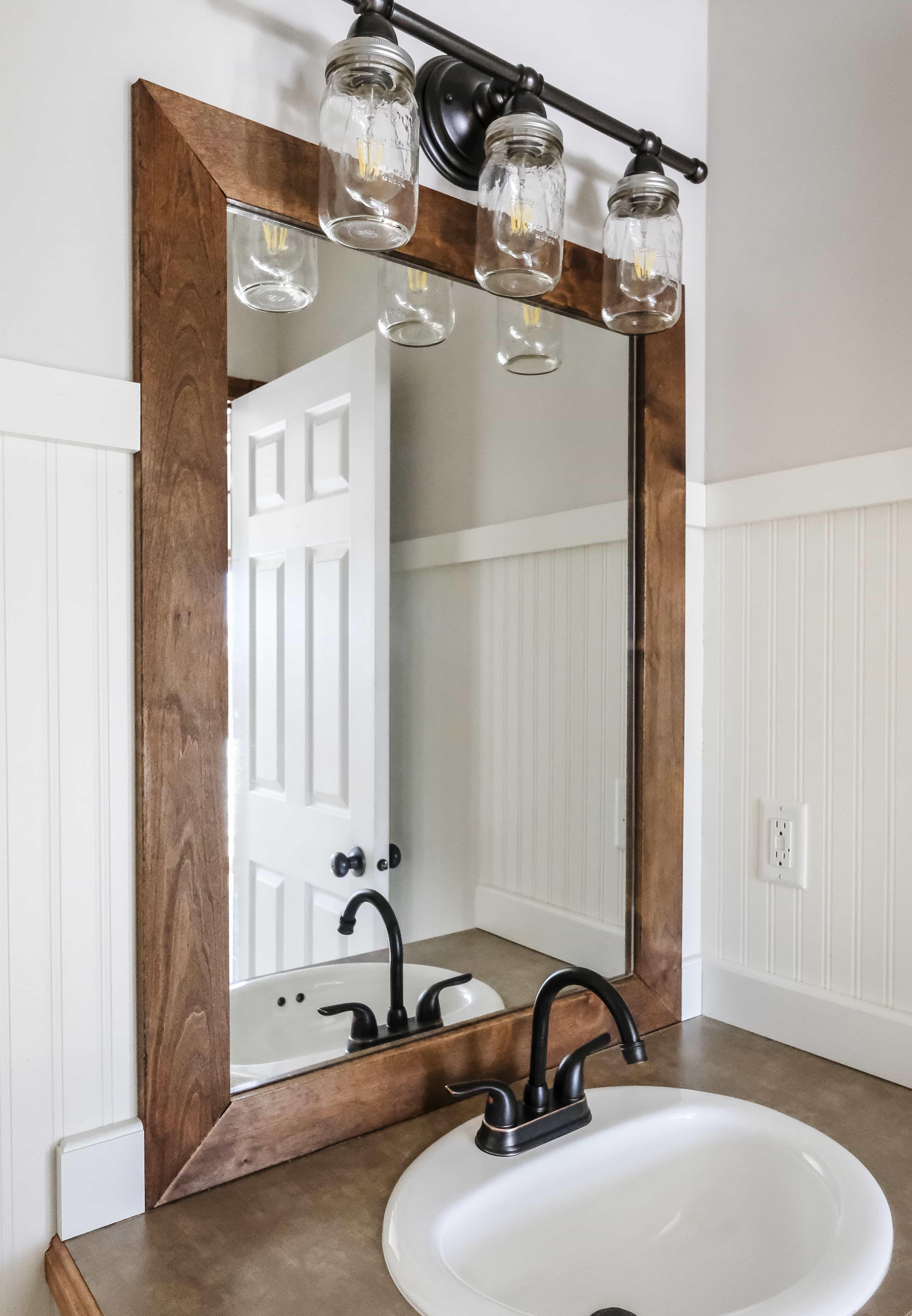 Add wooden trim around mirrors to give ‍your wooden bathroom a polished edge