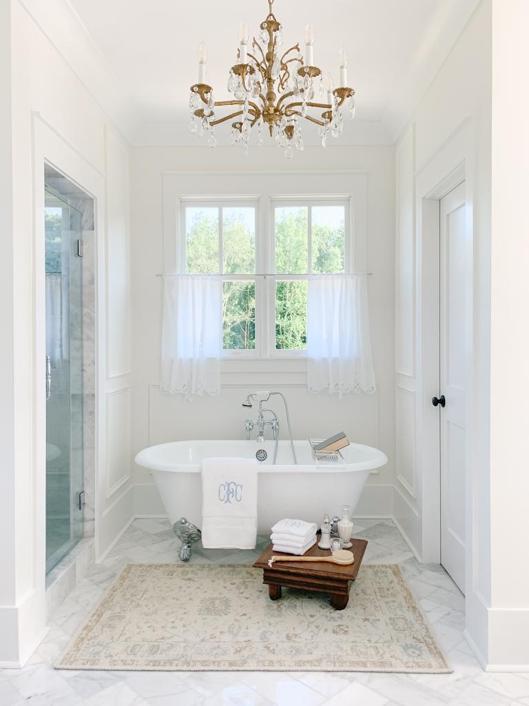 Vintage clawfoot tub adds timeless elegance to‌ your farmhouse bathroom