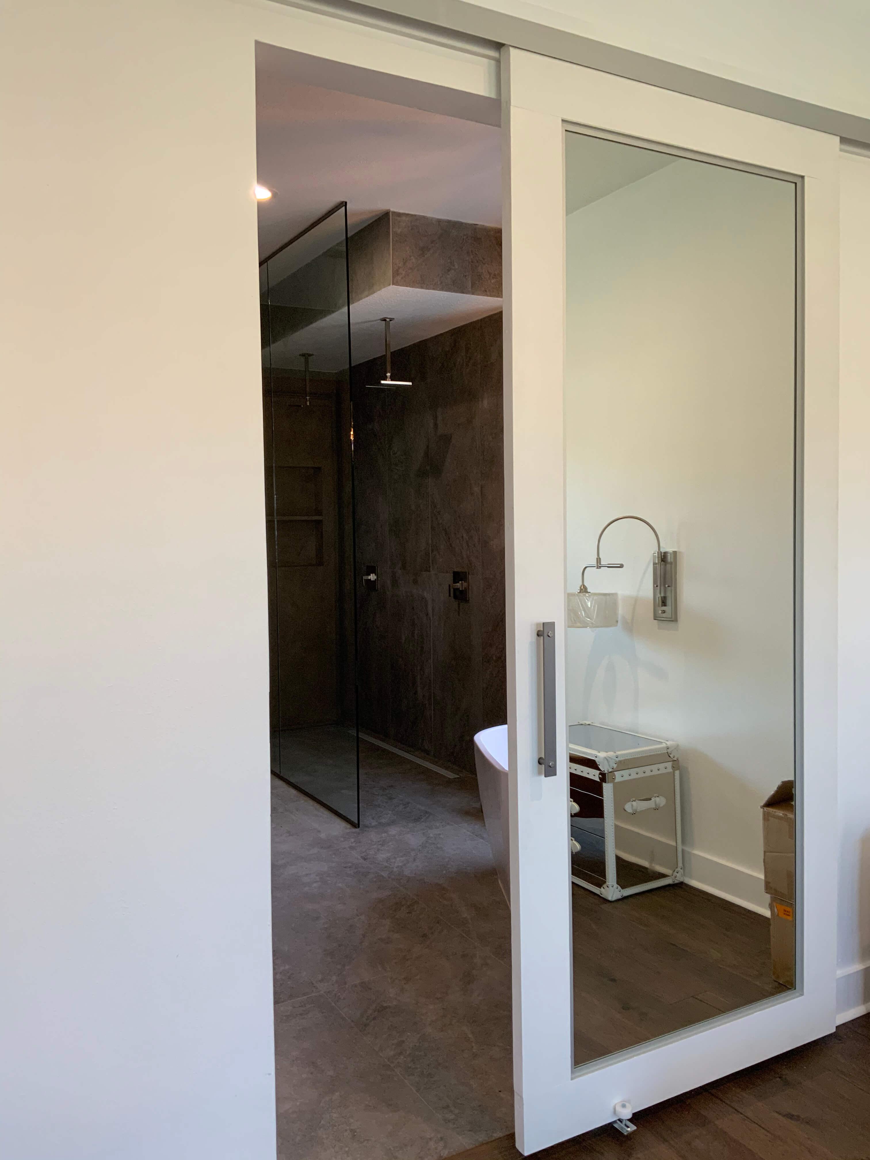 Install a wooden sliding door for a stylish entrance to your wooden bathroom