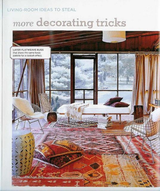 Layer rugs to define spaces on your welcoming screened porch