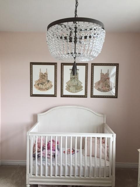 Hang artwork high to draw the eye upward in small nursery