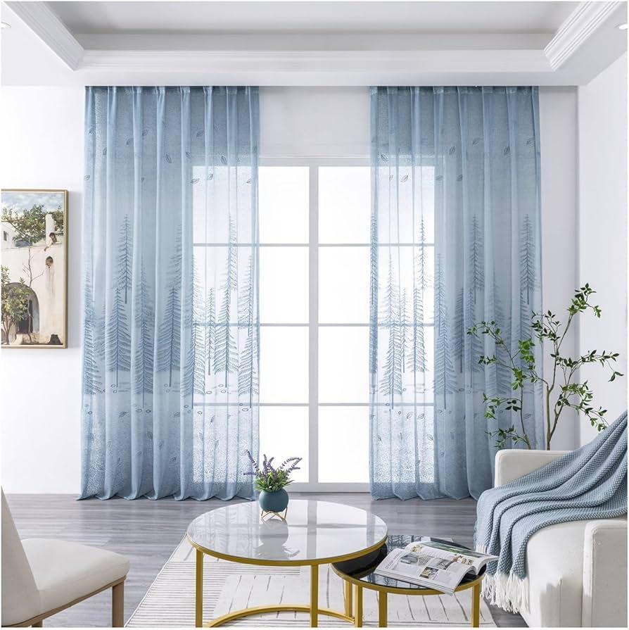 Use sheer curtains to soften⁣ light in your blue living room