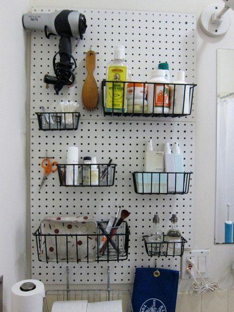 Utilize a pegboard for efficient organization in​ your farmhouse bathroom