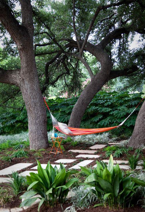 Inviting hammock strung between trees for lazy backyard afternoons