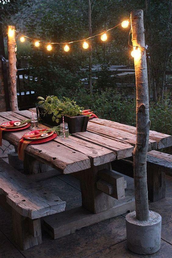 Explore ​a whimsical pallet garden featuring fairy lights and decor